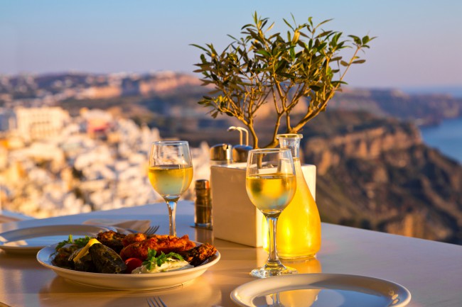 Dinner for two at sunset.Greece, Santorini, restaurant on the beach, above the volcano
